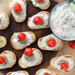 mini naan bread, topped with yogurt sauce, meatball, cucumber, tomato on a toothpick