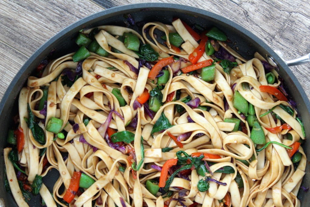 large skillet with sauced lo mein noodles and veggies